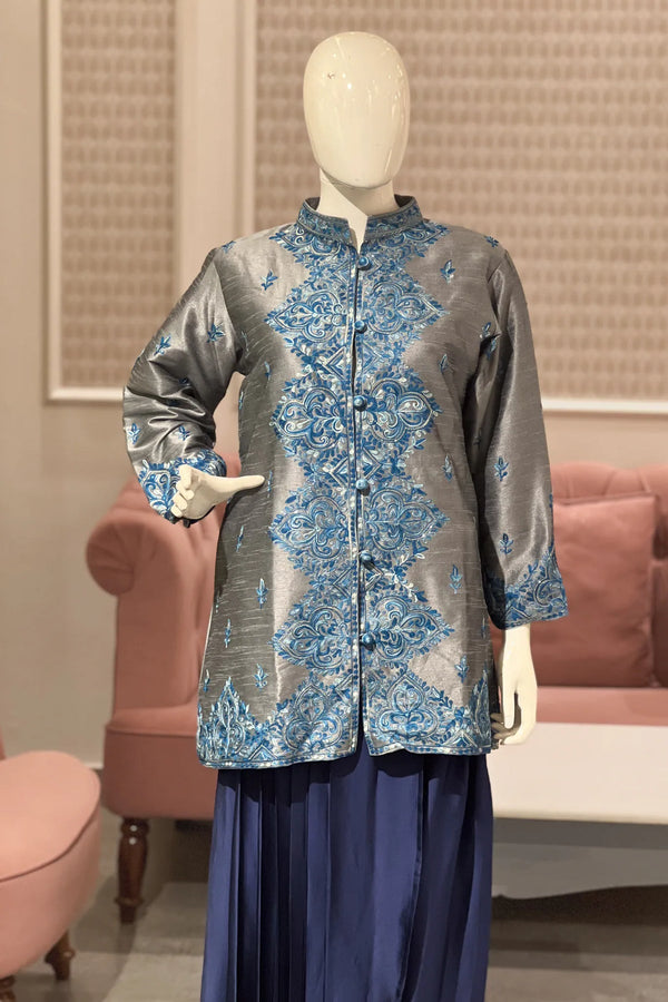 #grey Mannequin wearing a gray floral jacket with blue accents in an indoor setting.