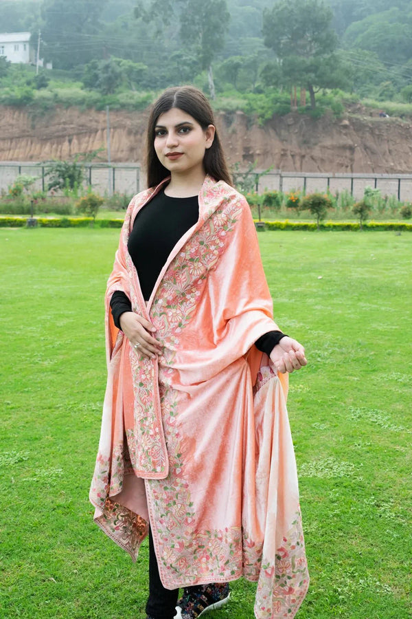 #Peach Woman wearing a peach floral dupatta over a black outfit on a grassy field