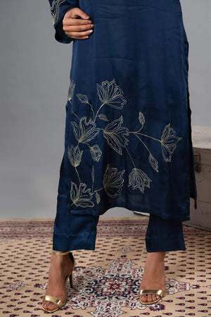 Navy blue outfit with floral embroidery on a patterned rug