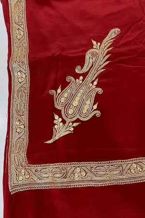 #Red fabric with gold embroidery on a white background