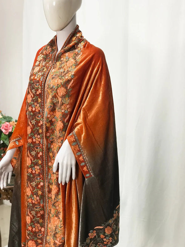#Orange Mannequin wearing an orange and black patterned garment against a white background