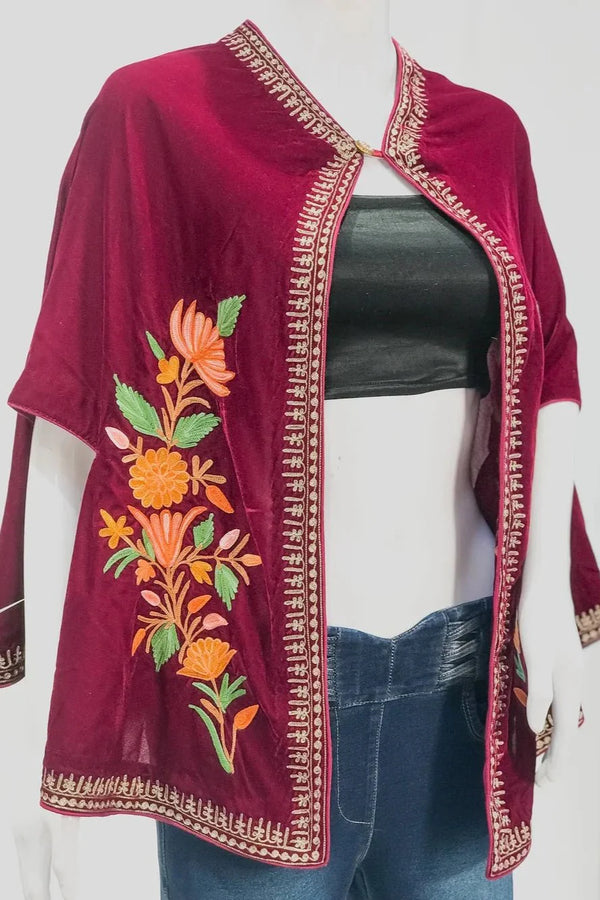 Maroon embroidered jacket on a mannequin with a white background