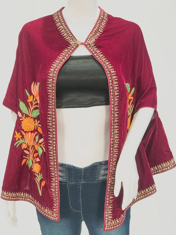 Maroon embroidered top on a mannequin with a white background
