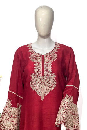 #Red embroidered dress on a mannequin against a white background