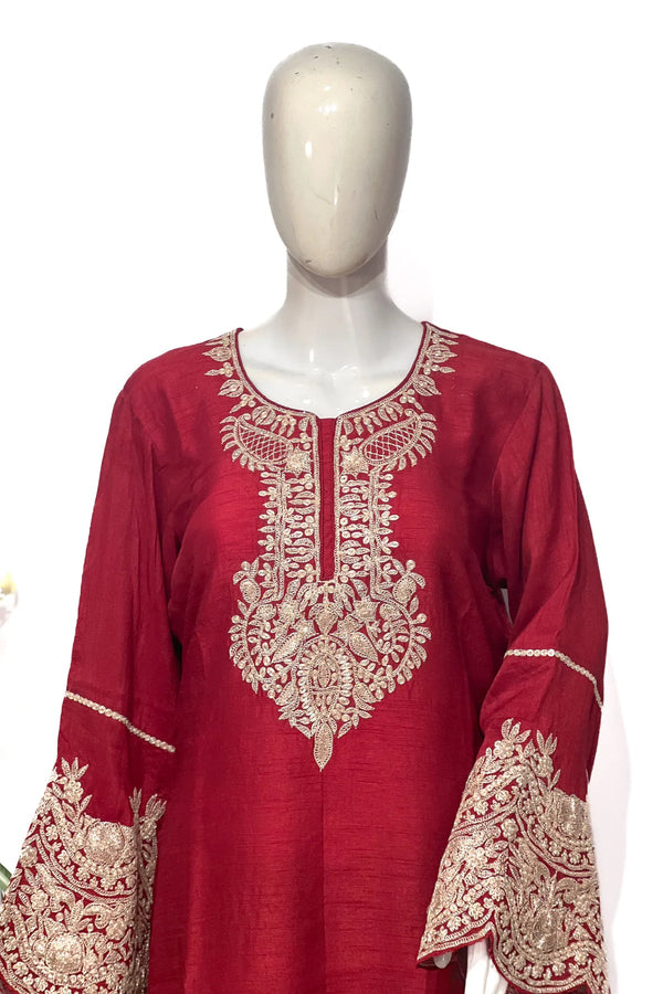 #Red embroidered dress on a mannequin against a white background