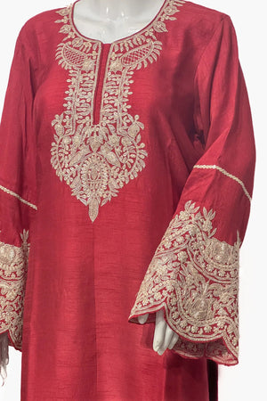 #Red embroidered garment on a mannequin with a white background