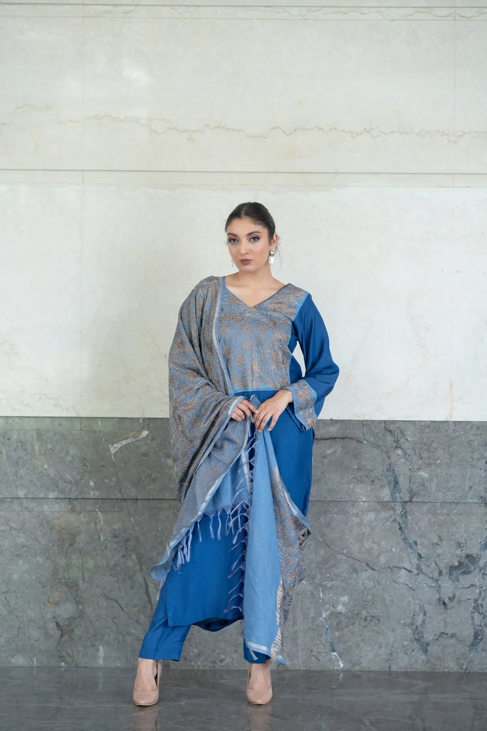 A woman modeling a floral embroidered straight kurta and pants set with a dupatta in a grey and blue color scheme.
#AquaBlue
