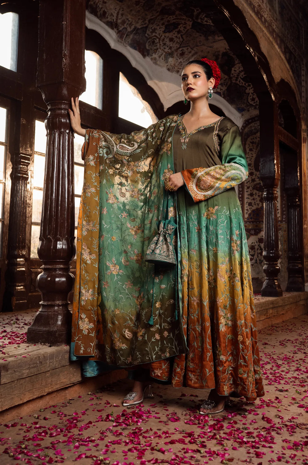 Woman in a traditional outfit with floral patterns in an ornate interior setting