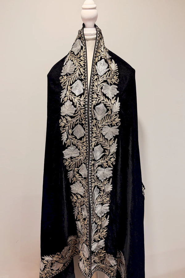 #Black embroidered garment on a mannequin against a plain background
