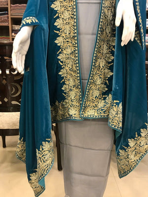 #Turquoise Teal outfit with gold embroidery on a mannequin in a store setting