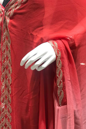 Red fabric with gold embroidery on a mannequin arm