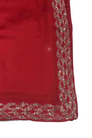 Red fabric with silver embroidery on a white background