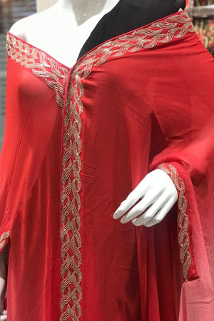 Red dress with gold embroidery on a mannequin